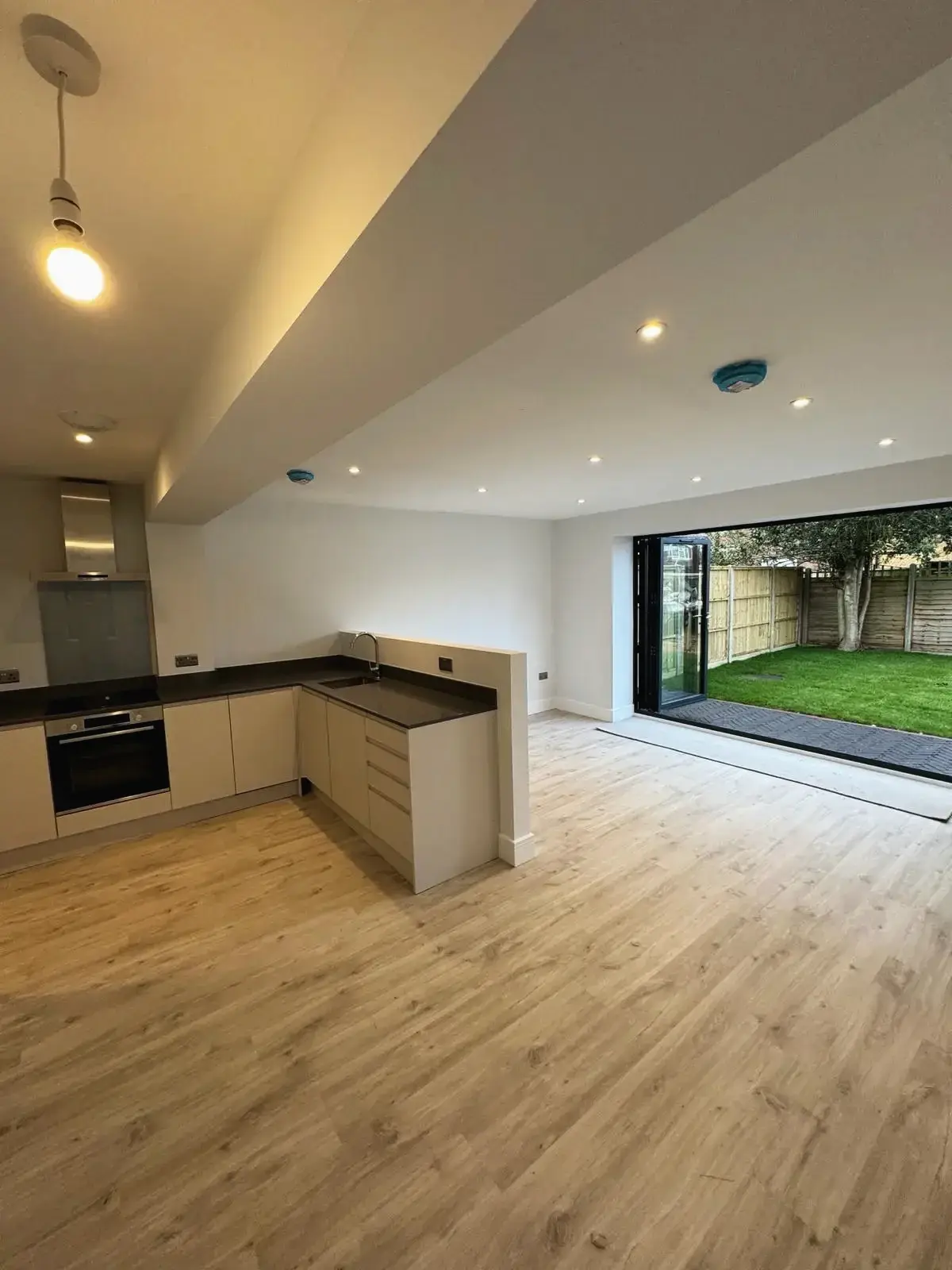 Open-plan kitchen with wide glazed doors opening onto the garden