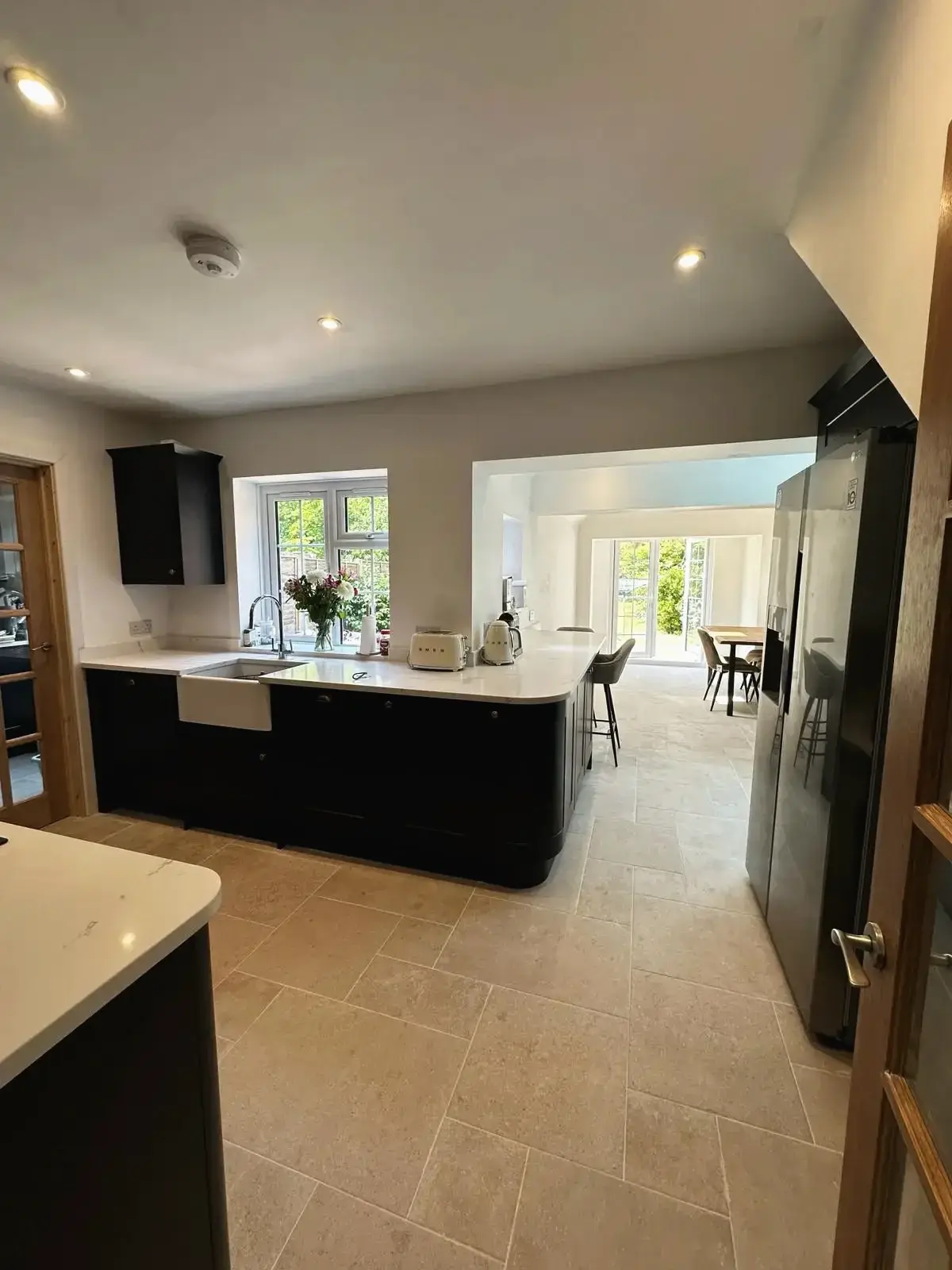Kitchen island with seating, opening into a bright extension